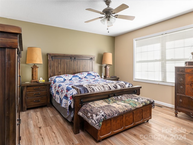 bedroom with ceiling fan and light wood-type flooring