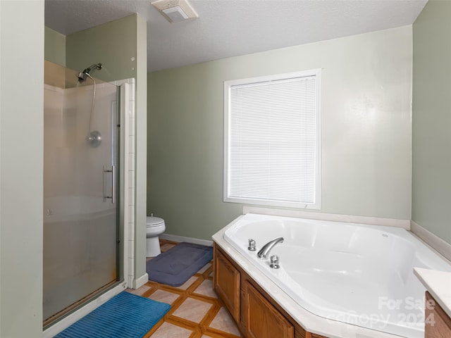 full bathroom with shower with separate bathtub, toilet, tile flooring, a textured ceiling, and vanity