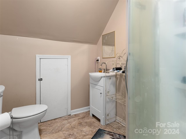 bathroom featuring toilet, vanity, and tile flooring