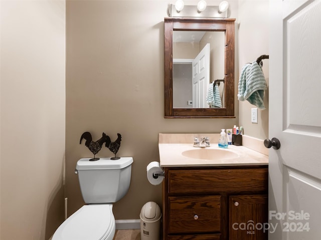 bathroom featuring toilet and vanity