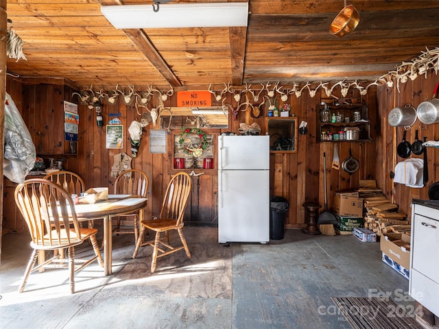 unfurnished dining area featuring wooden walls