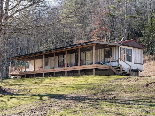 rear view of property with a yard