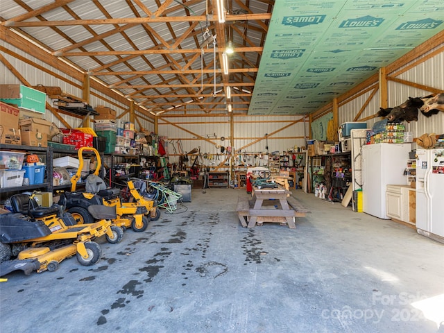 garage featuring white fridge with ice dispenser