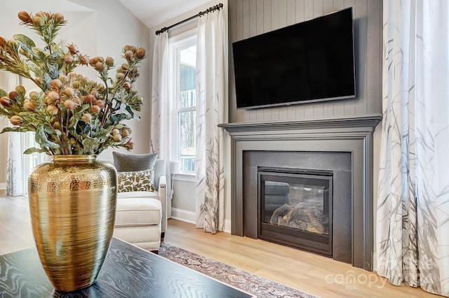 sitting room featuring vaulted ceiling and light hardwood / wood-style flooring