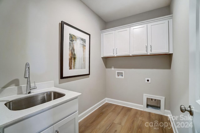 washroom with sink, hookup for a washing machine, electric dryer hookup, cabinets, and light wood-type flooring