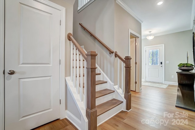 interior space featuring ornamental molding and light hardwood / wood-style floors