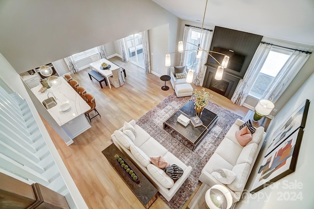 living room with light hardwood / wood-style flooring and a high ceiling