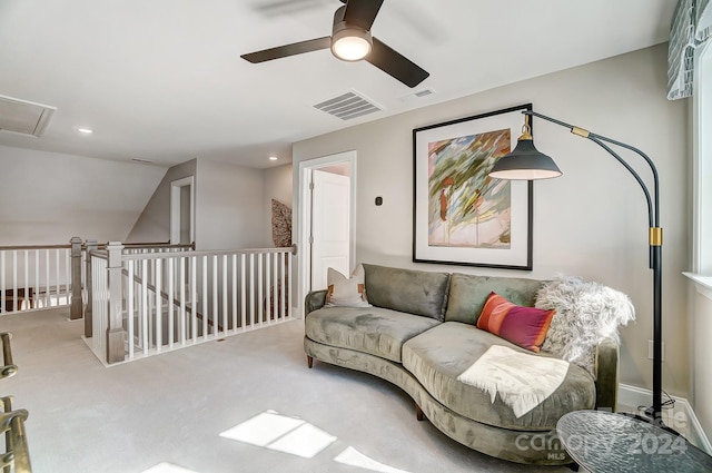 living room with ceiling fan, lofted ceiling, and light colored carpet