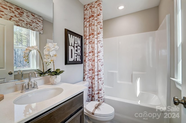 full bathroom with toilet, shower / tub combo with curtain, and large vanity