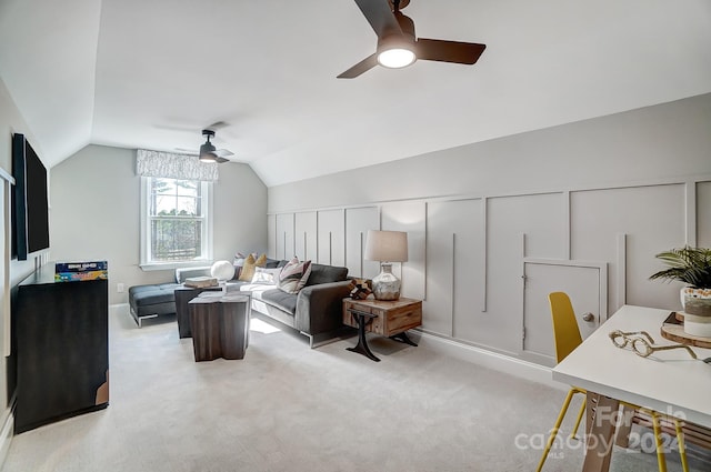 living room with ceiling fan, vaulted ceiling, and light colored carpet