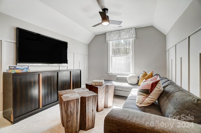 living room with ceiling fan, lofted ceiling, and light colored carpet