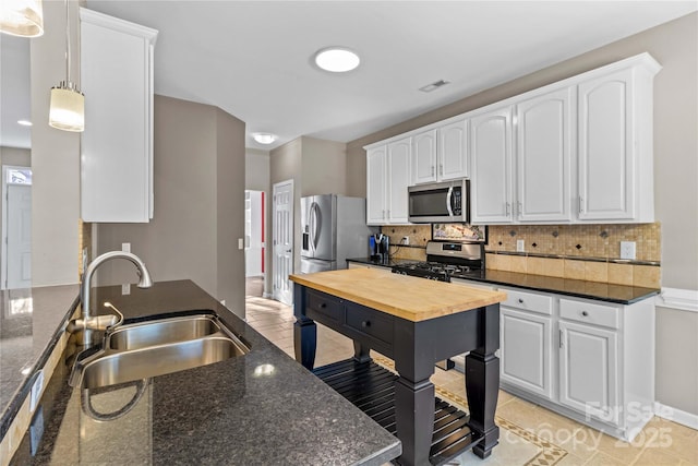 kitchen with sink, white cabinets, and appliances with stainless steel finishes