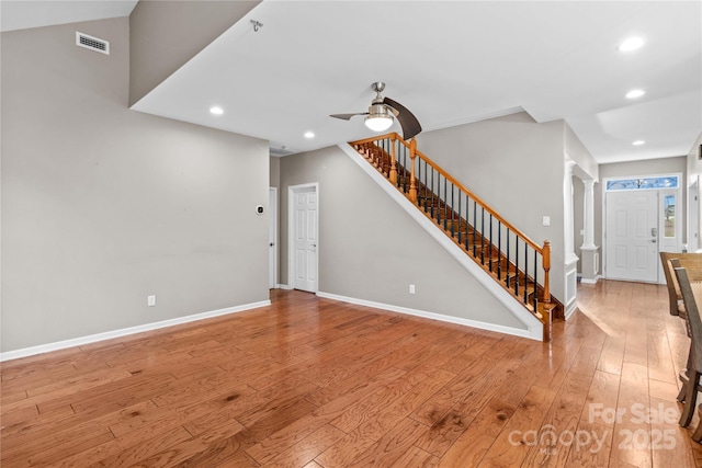 unfurnished living room with ceiling fan, light hardwood / wood-style floors, and decorative columns