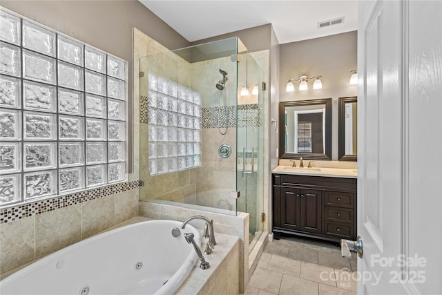 bathroom with tile patterned floors, vanity, and plus walk in shower