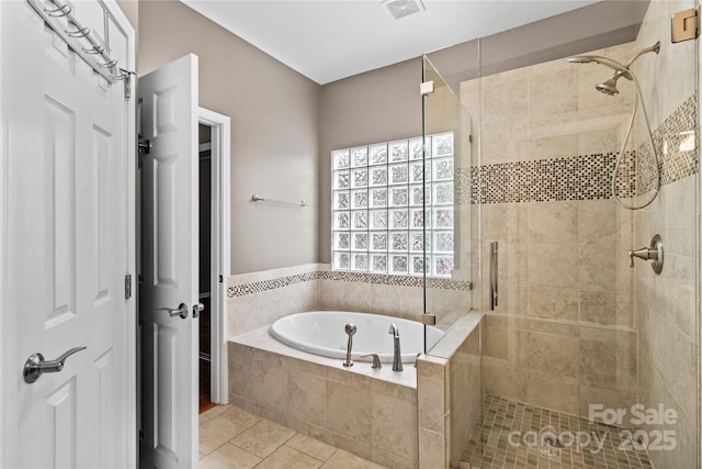 bathroom with tile patterned floors and plus walk in shower