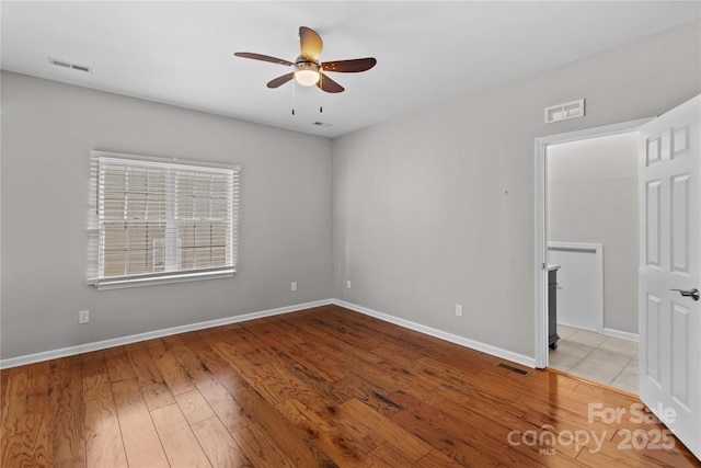 spare room with ceiling fan and light hardwood / wood-style flooring