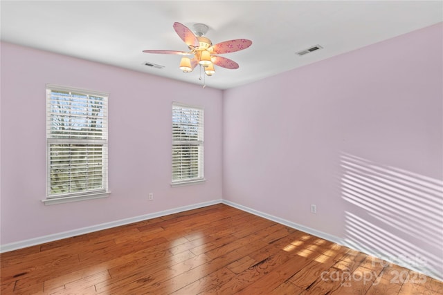 spare room featuring hardwood / wood-style floors and ceiling fan