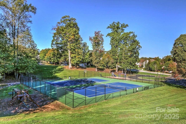 view of tennis court featuring a yard