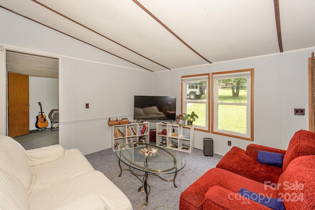 carpeted living room with vaulted ceiling with beams