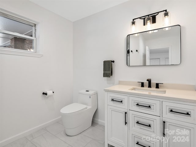 bathroom with toilet and vanity