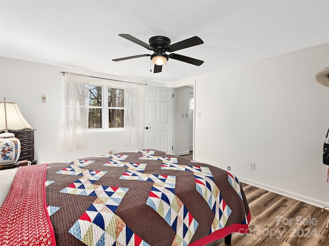 bedroom with ceiling fan and dark hardwood / wood-style floors