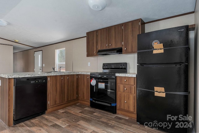 kitchen with dark hardwood / wood-style floors, a textured ceiling, black appliances, and sink