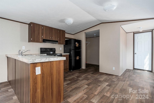 kitchen with extractor fan, sink, dark hardwood / wood-style flooring, lofted ceiling, and black fridge