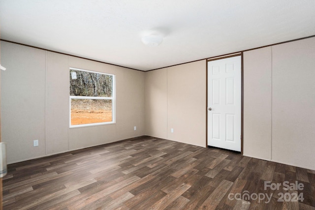 unfurnished room with dark hardwood / wood-style floors