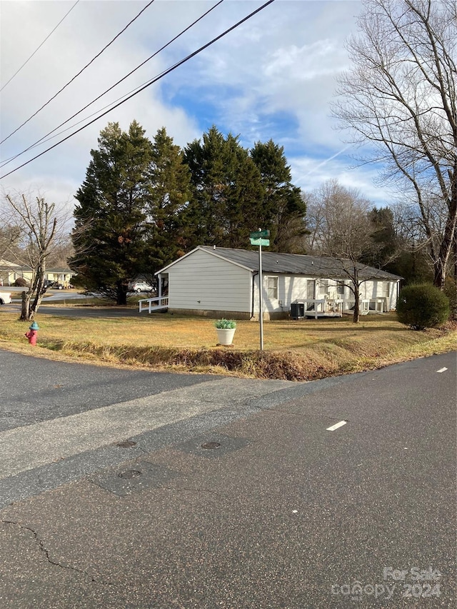 view of home's exterior featuring a lawn and central AC unit