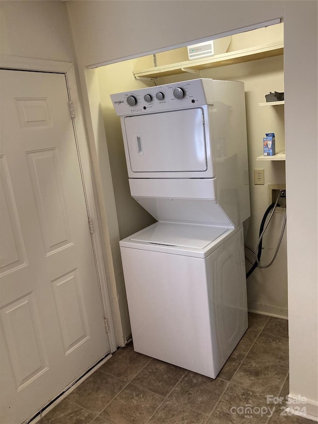 washroom featuring stacked washer and clothes dryer