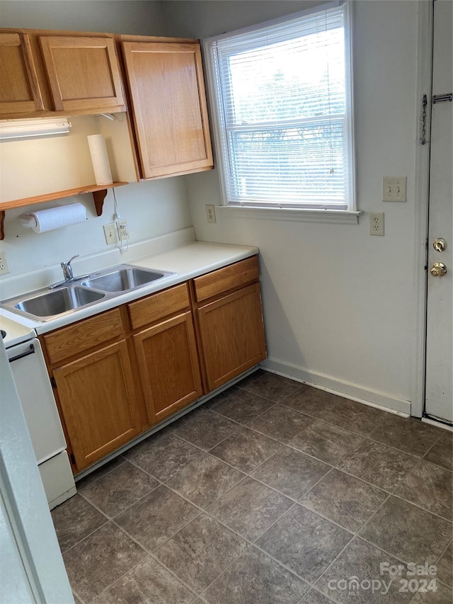 kitchen featuring white range oven and sink