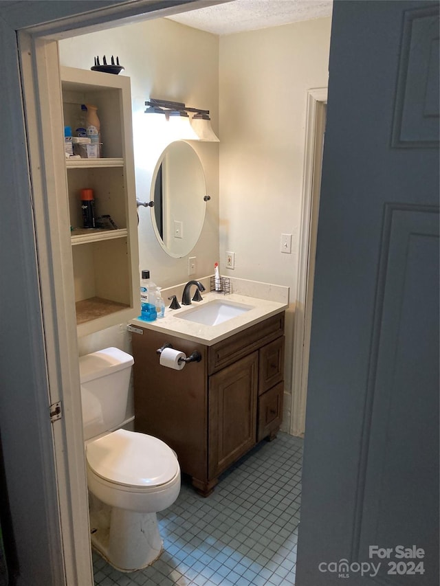 100 Normandy Dr, Morganton, NC 28655 - bathroom featuring tile patterned floors, a textured ceiling, toilet, and vanity