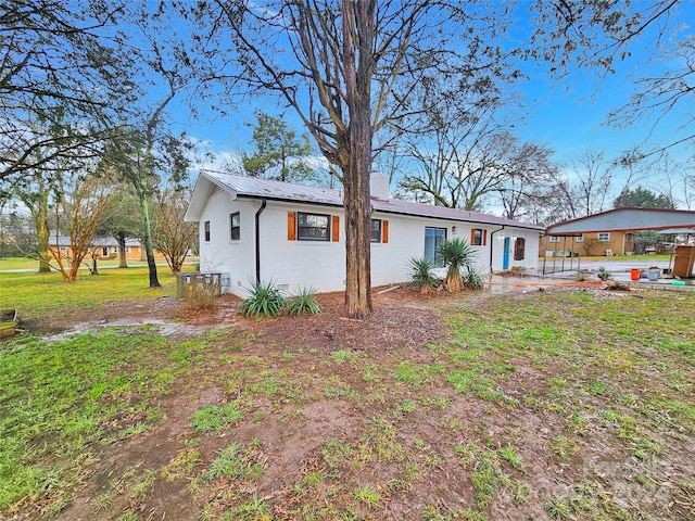 back of property featuring a lawn