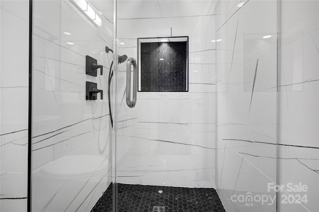 bathroom featuring a shower with shower door