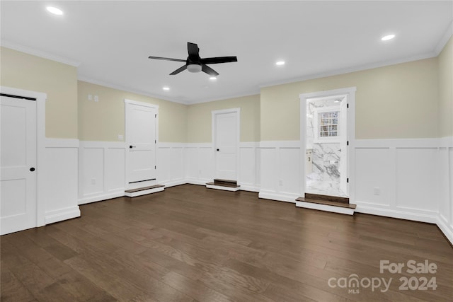 spare room with ceiling fan, dark wood-type flooring, and crown molding