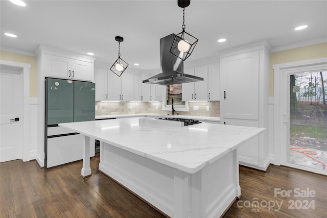 kitchen with a center island, stainless steel fridge, white cabinets, and island range hood