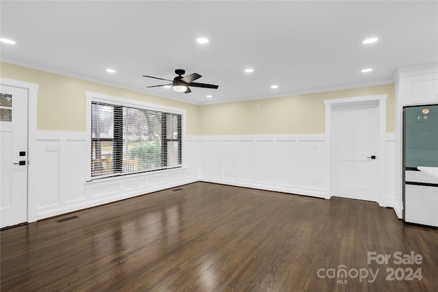 spare room featuring ornamental molding, ceiling fan, and dark hardwood / wood-style floors