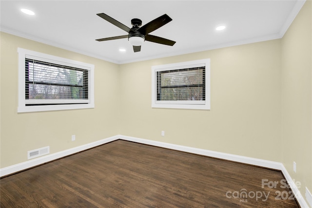 unfurnished room featuring dark hardwood / wood-style flooring, ceiling fan, ornamental molding, and plenty of natural light