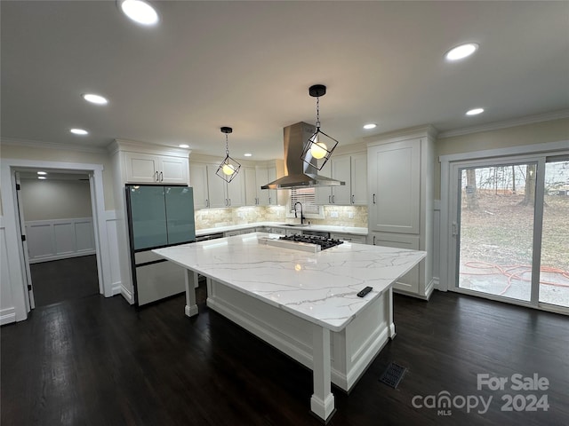 kitchen with white cabinets, dark hardwood / wood-style floors, a center island, and island exhaust hood