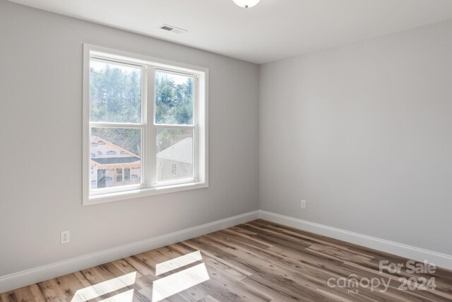 spare room featuring light wood-type flooring