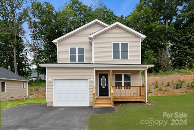 front of property with a garage, a porch, and a front yard