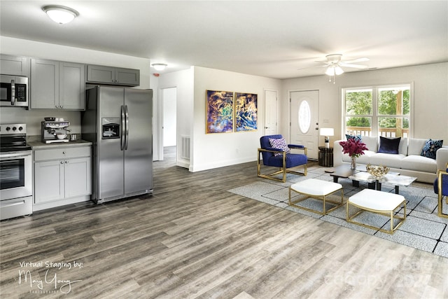 living room with ceiling fan and dark wood-type flooring