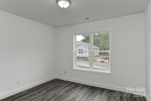 empty room with dark hardwood / wood-style floors