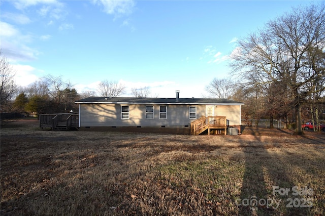 back of house featuring a lawn, central AC, and a deck