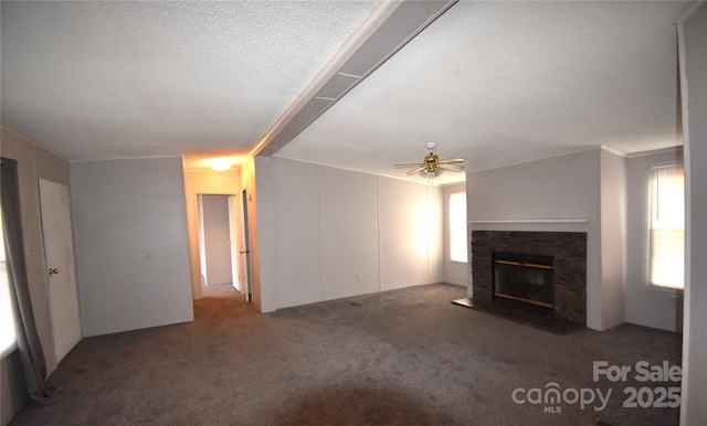 unfurnished living room featuring a textured ceiling, ceiling fan, and dark carpet