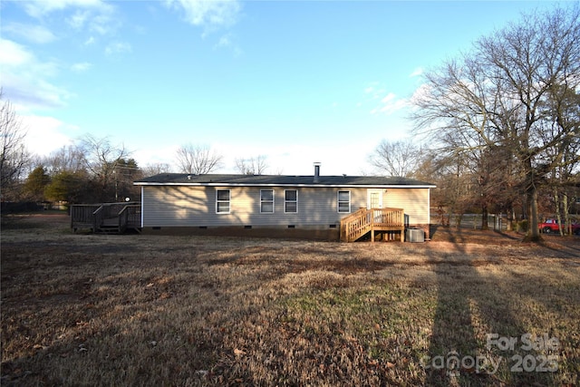 rear view of house featuring a deck, a yard, and central air condition unit