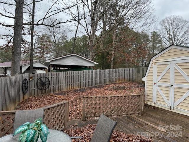 view of yard with a deck and a storage shed