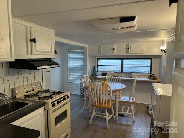 kitchen with tasteful backsplash, dark wood-type flooring, white cabinetry, and white gas stove