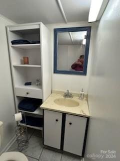 bathroom with tile floors, toilet, and vanity