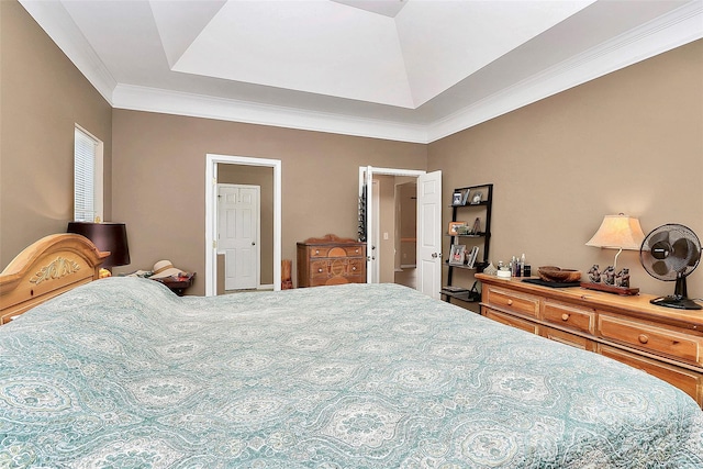 bedroom with a raised ceiling and crown molding